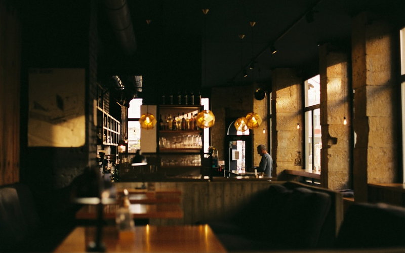 Restaurant at Aurora District with warm lighting and elegant table settings